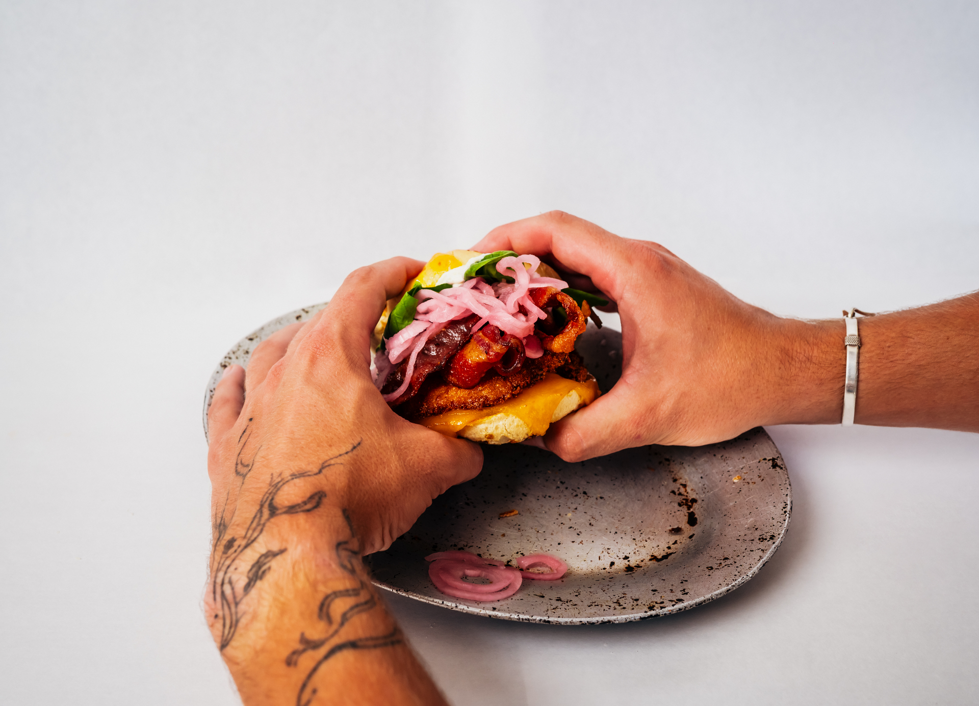 Hands holding a Sam & Jack's grab & go dinner